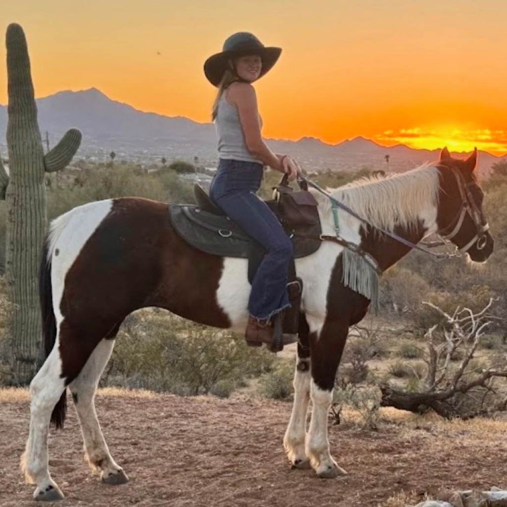 Horseback Riding Lessons in Tucson Rider on a paint horse at sunset during a horseback riding lesson at Catalina Riding Club in Tucson, Arizona